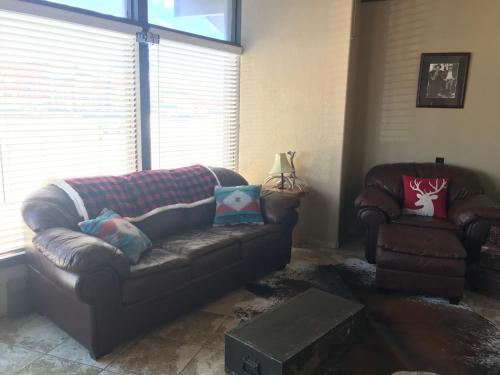 a living room with a couch and a chair at Country West Motel of Rock Springs in Rock Springs