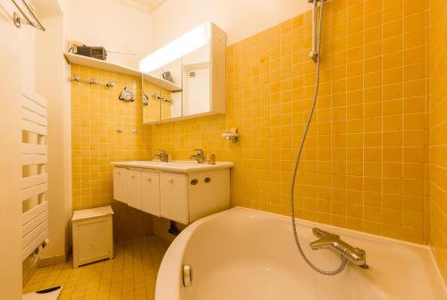 a bathroom with a tub and a sink at Veeve - Classic Montparnasse in Paris