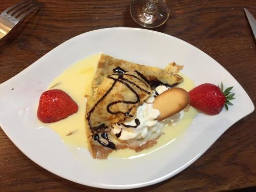 a white plate with a piece of dessert with strawberries at Villa Motel in Stenay