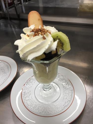 a dessert in a glass sitting on a plate at Villa Motel in Stenay