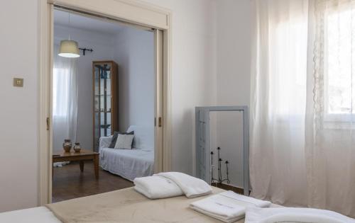 a bedroom with a mirror and a bed in a room at Uncle's Titikas Adamas in Adamas