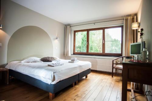 Ένα ή περισσότερα κρεβάτια σε δωμάτιο στο B&B De Meren