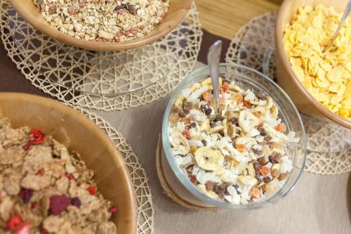 a table topped with bowls of food and desserts at Grand Hotel Gortani in Arta Terme