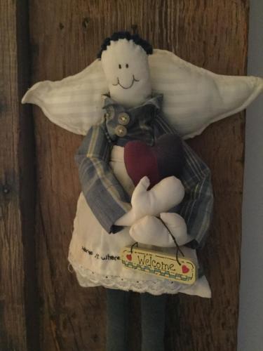 a stuffed angel holding a heart and a pillow at Heartwood Barn in Ticehurst