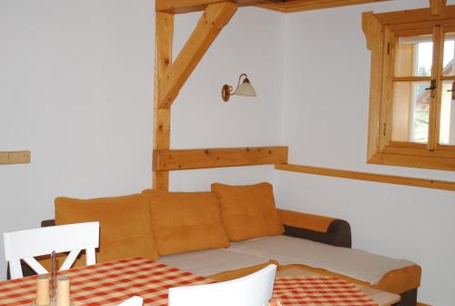 a room with a couch and a table and a window at Roubenka-Mila in Ostružná