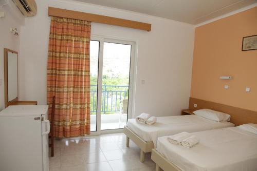 Ένα ή περισσότερα κρεβάτια σε δωμάτιο στο Kastelli Hotel, Afandou