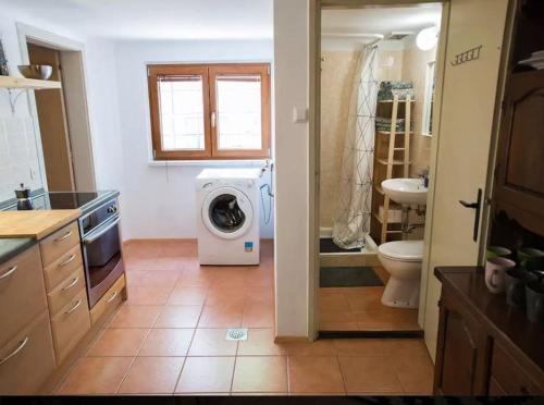 a kitchen with a washing machine in a bathroom at Mediterranean Family design in Izola