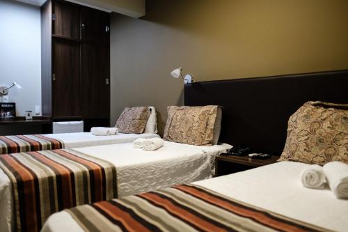 מיטה או מיטות בחדר ב-Ideali Hotel