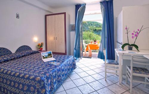 a bedroom with a bed with a laptop on it at Hotel Residence S.Angelo in Ischia