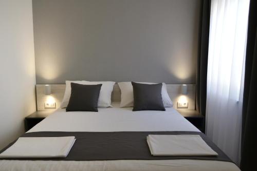 a bedroom with a large white bed with pillows at VILLA ŠUŠANJ 2 in Cesarica