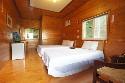 Un ou plusieurs lits dans un hébergement de l'établissement Fumei Bluebird Homestay