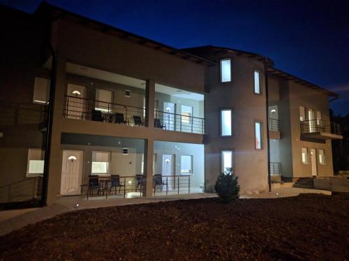 a large apartment building with its lights on at night at Simića ćoše in Vrdnik