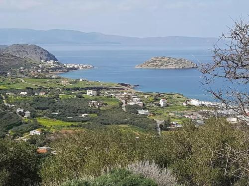 a village on a hill with the ocean in the background at Mochlos Beach Villa Seafront house in Mochlos