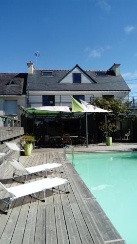 una piscina con sillas y sombrillas junto a una casa en Un dimanche à la campagne, en Brech