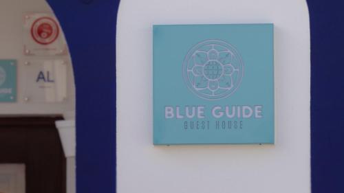 a blue guide sign on a white wall at BLUE GUIDE Milfontes in Vila Nova de Milfontes