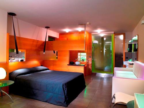 a bedroom with a bed and a living room at Hotel Zone in Rome