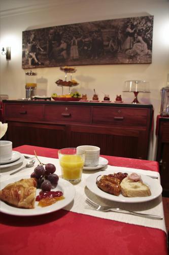 a table with plates of food on a red table at O Casario in Mirandela