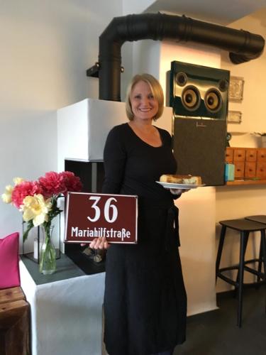a woman holding a box with a sign that at Faktorei in Innsbruck