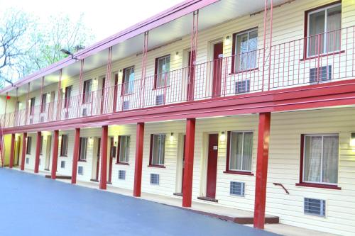 a large white building with red columns and windows at Passport Inn Niagara Falls in Niagara Falls