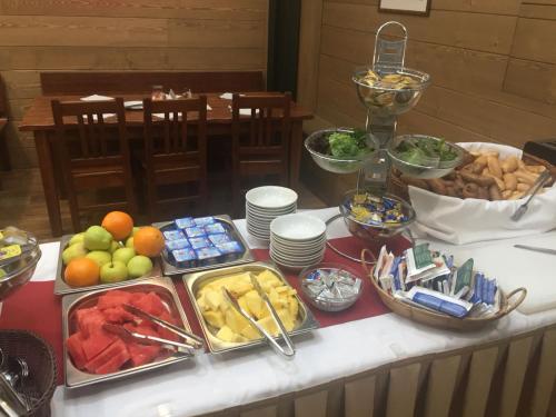 a buffet of food on a table with plates of food at U Medvidku-Brewery Hotel in Prague
