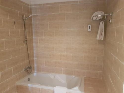 a bathroom with a tub and a shower with a toilet at Green Sudr Resort in Ras Sedr