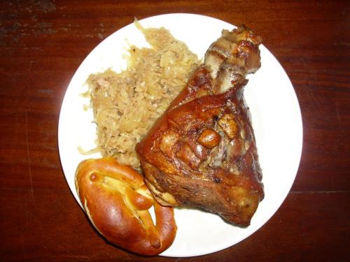 a plate of food with meat and rice on a table at Rainbow Village in La Ceiba