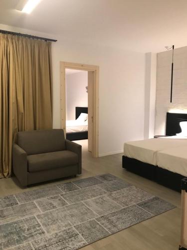 a bedroom with a bed and a couch and a bed at Abacus Suites in Ayia Napa