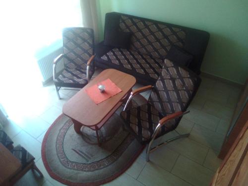 a table and two chairs in a room at Ośrodek Wczasowy "GRONOSTAJ" in Rajcza
