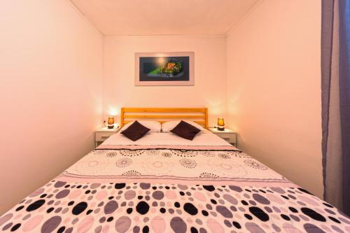 a bedroom with a bed and two night stands at Apartment Nino in Skradin