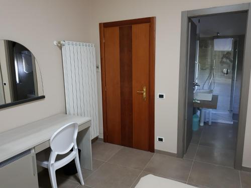 a room with a desk and a chair and a door at Hotel Francesco in Padenghe sul Garda