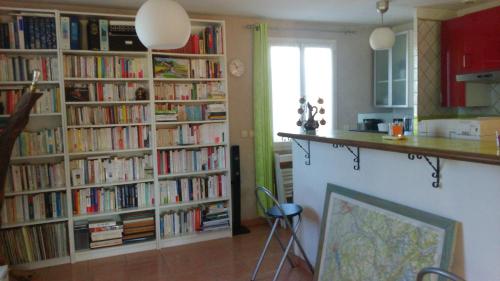 une cuisine avec plusieurs étagères remplies de livres dans l'établissement Bio verdon, à Régusse