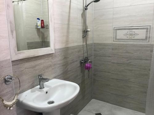 a bathroom with a sink and a shower at Guest House kartvelishvili in Batumi