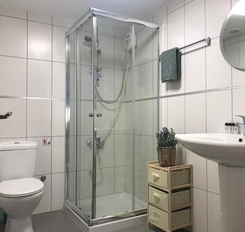 a bathroom with a shower and a toilet and a sink at MCPlaces Holiday Apartments in Paphos