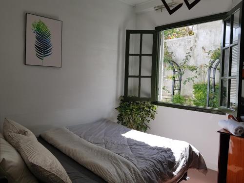 a bed in a room with a window at Six Six Garden in Da Lat