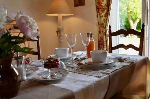 einen Tisch mit einem weißen Tischtuch und Weingläsern in der Unterkunft L ' Authentique in Pernes-lès-Boulogne