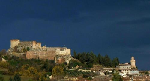 a castle on top of a hill with trees at Hotel Prati in Castrocaro Terme