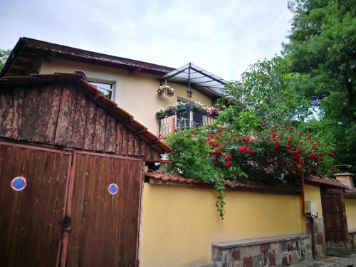 a house with a balcony with flowers on it at Hotel Paradise in Sofia