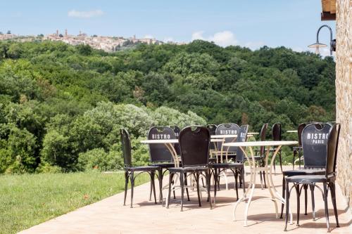 a group of black chairs and a table with a view at Casanova di Neri Relais in Montalcino