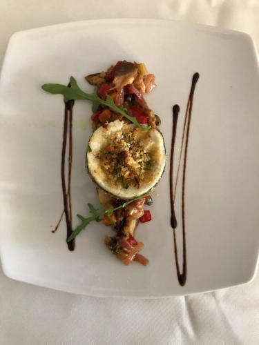 a white plate with a piece of food on it at Hotel La Sirenetta in Giardini Naxos