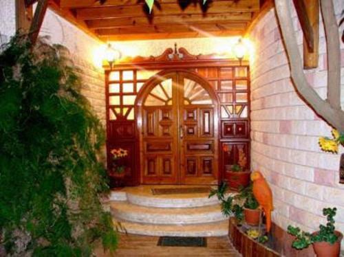 a house with a large wooden door and stairs at Hadar Bakfar in Yesod Hamaala