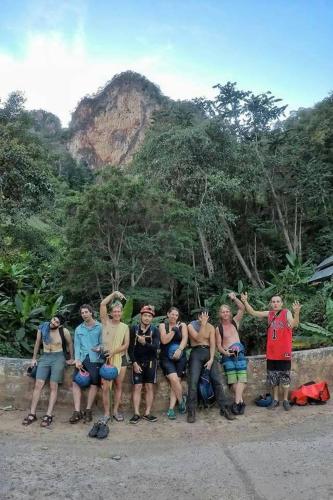 a group of people posing in front of a mountain at Cave Lodge in Pang Mapha