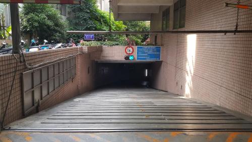 a tunnel leading into a building with a sign on it at 友愛金色商旅Golden Age Hotel in Taipei