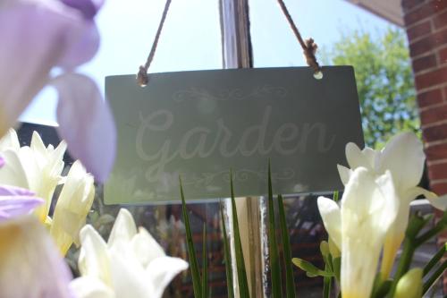 a sign for a garden with white flowers at Greyfriars Lodge Canterbury in Canterbury