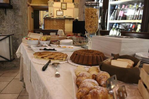 a table with pastries and other food on it at Villa Cosilinum in Padula
