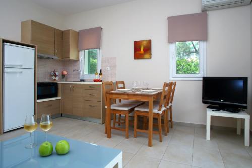 a kitchen with a table and a dining room at Villa Maria in Tsoukaladhes