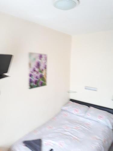 a bed in a room with a picture on the wall at Montgomery Hotel in Blackpool