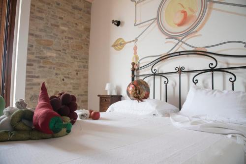 a bedroom with a bed with stuffed animals on it at Tenuta Porello in Rocca San Giovanni