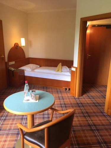a hotel room with a bed and a table at Hotel Liebmann in Lassnitzhöhe