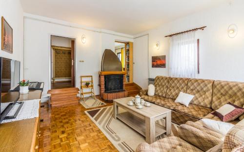 a living room with a couch and a fireplace at Three-Bedroom Apartment Meden in Pomer