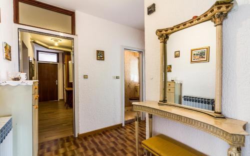 a mirror on a wall next to a hallway at Three-Bedroom Apartment Meden in Pomer
